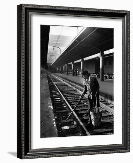 African American Woman Picking Up Debris on Tracks at Union Station-Alfred Eisenstaedt-Framed Photographic Print