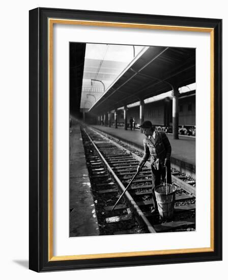 African American Woman Picking Up Debris on Tracks at Union Station-Alfred Eisenstaedt-Framed Photographic Print