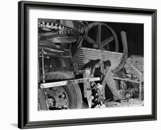 African American Worker Mrs. Rosalie Ivy Using Shovel to Mix a Special Mud Used to Seal the Hole-Margaret Bourke-White-Framed Photographic Print