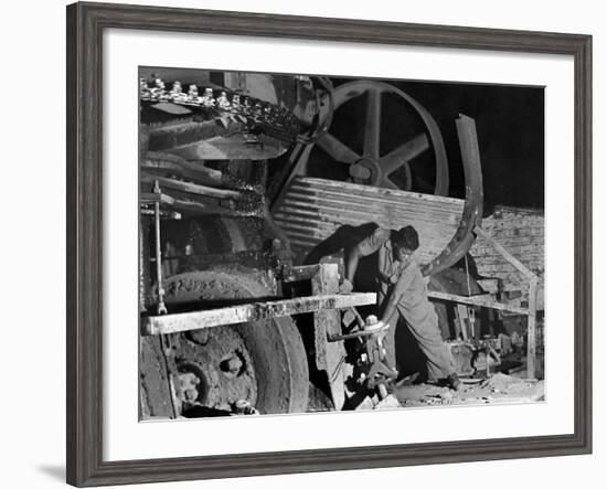 African American Worker Mrs. Rosalie Ivy Using Shovel to Mix a Special Mud Used to Seal the Hole-Margaret Bourke-White-Framed Photographic Print