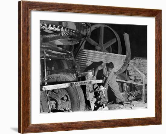 African American Worker Mrs. Rosalie Ivy Using Shovel to Mix a Special Mud Used to Seal the Hole-Margaret Bourke-White-Framed Photographic Print