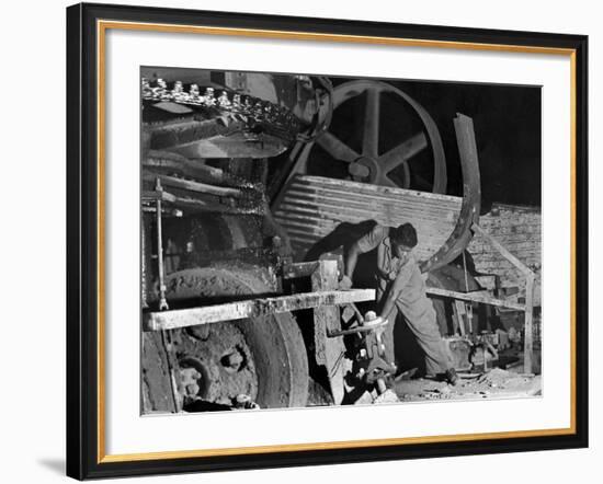 African American Worker Mrs. Rosalie Ivy Using Shovel to Mix a Special Mud Used to Seal the Hole-Margaret Bourke-White-Framed Photographic Print