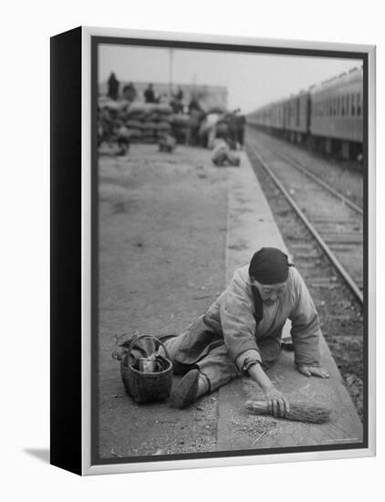 Aged Refugee Fighting Hunger, Sweeps Up Spilled Rice on the Railroad Station Platform-Jack Birns-Framed Premier Image Canvas