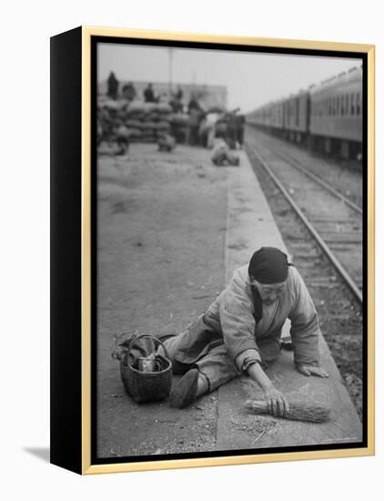 Aged Refugee Fighting Hunger, Sweeps Up Spilled Rice on the Railroad Station Platform-Jack Birns-Framed Premier Image Canvas