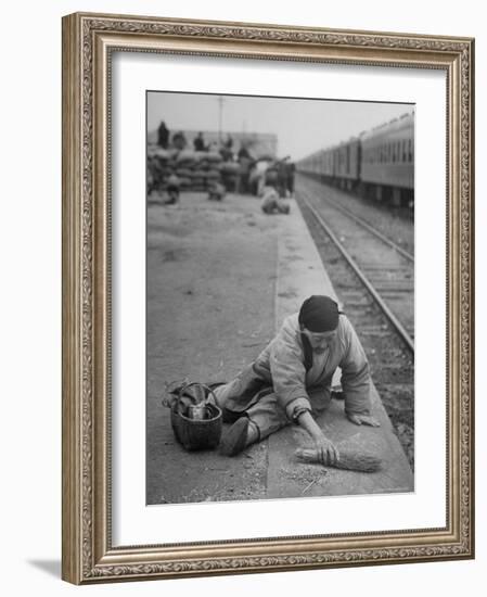 Aged Refugee Fighting Hunger, Sweeps Up Spilled Rice on the Railroad Station Platform-Jack Birns-Framed Photographic Print