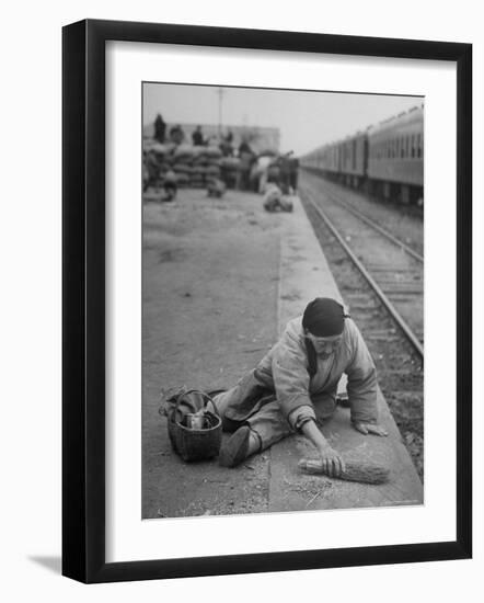 Aged Refugee Fighting Hunger, Sweeps Up Spilled Rice on the Railroad Station Platform-Jack Birns-Framed Photographic Print