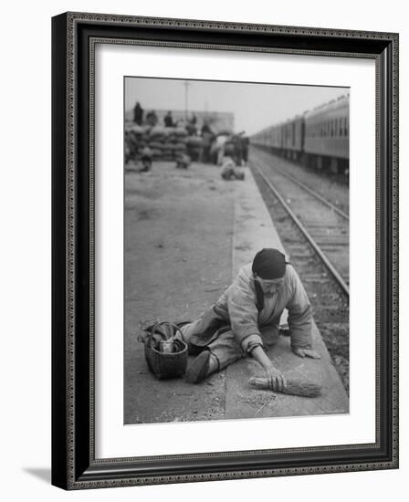 Aged Refugee Fighting Hunger, Sweeps Up Spilled Rice on the Railroad Station Platform-Jack Birns-Framed Photographic Print