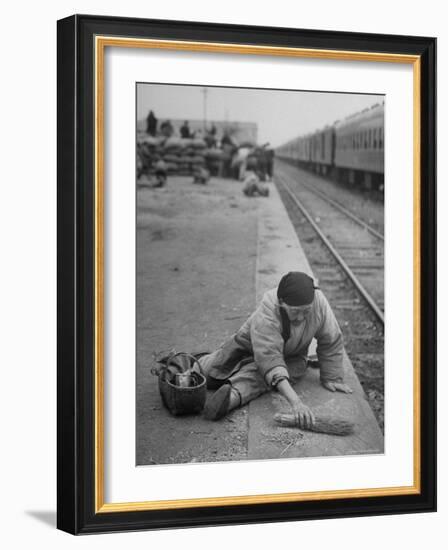 Aged Refugee Fighting Hunger, Sweeps Up Spilled Rice on the Railroad Station Platform-Jack Birns-Framed Photographic Print