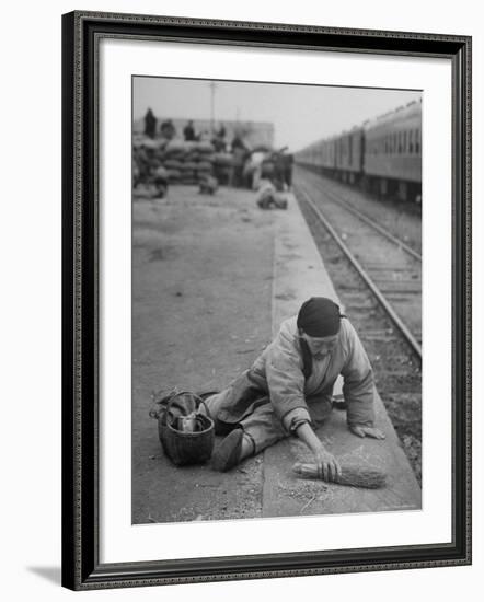 Aged Refugee Fighting Hunger, Sweeps Up Spilled Rice on the Railroad Station Platform-Jack Birns-Framed Photographic Print