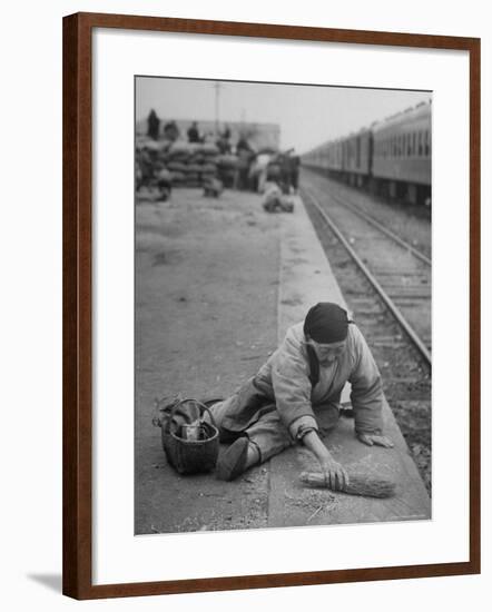 Aged Refugee Fighting Hunger, Sweeps Up Spilled Rice on the Railroad Station Platform-Jack Birns-Framed Photographic Print