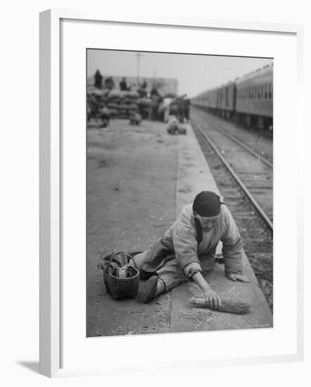 Aged Refugee Fighting Hunger, Sweeps Up Spilled Rice on the Railroad Station Platform-Jack Birns-Framed Photographic Print