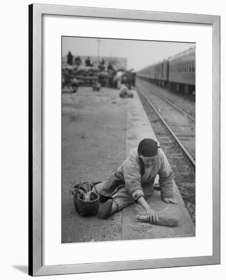 Aged Refugee Fighting Hunger, Sweeps Up Spilled Rice on the Railroad Station Platform-Jack Birns-Framed Photographic Print