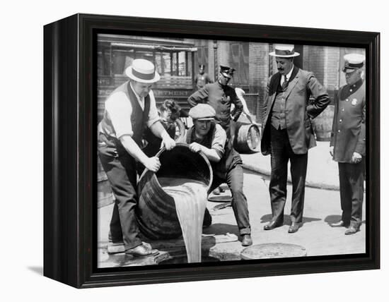 Agents pour liquor into sewer following a raid during the height of prohibition, New York, 1921-null-Framed Premier Image Canvas