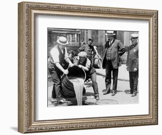 Agents pour liquor into sewer following a raid during the height of prohibition, New York, 1921-null-Framed Photographic Print