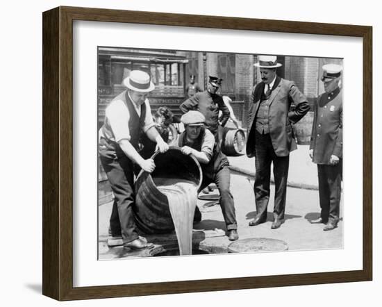 Agents pour liquor into sewer following a raid during the height of prohibition, New York, 1921-null-Framed Photographic Print