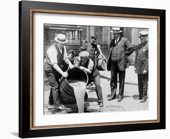 Agents pour liquor into sewer following a raid during the height of prohibition, New York, 1921-null-Framed Photographic Print