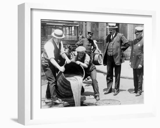 Agents pour liquor into sewer following a raid during the height of prohibition, New York, 1921-null-Framed Photographic Print