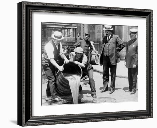 Agents pour liquor into sewer following a raid during the height of prohibition, New York, 1921-null-Framed Photographic Print