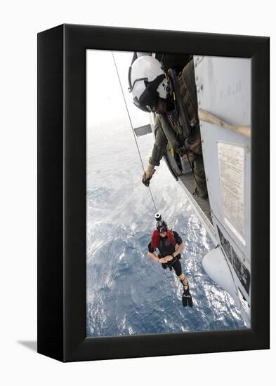 Aircrewman Assists in Hoisting a Member into an Mh-60S Sea Hawk-null-Framed Premier Image Canvas