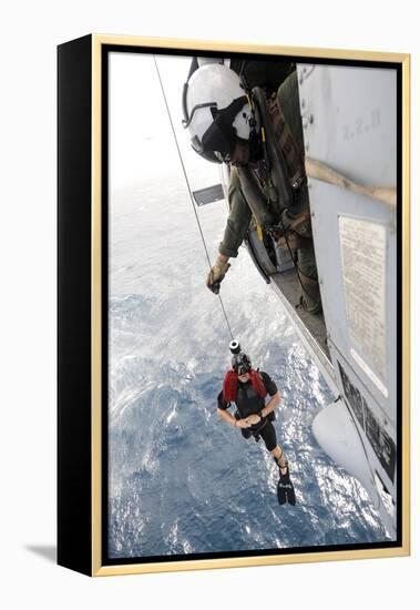 Aircrewman Assists in Hoisting a Member into an Mh-60S Sea Hawk-null-Framed Premier Image Canvas