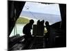 Airmen Push Out a Pallet of Donated Goods from a C-130 Hercules-Stocktrek Images-Mounted Photographic Print