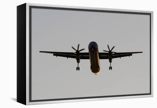 Airplane approaches with lowered wheels-Charles Bowman-Framed Premier Image Canvas