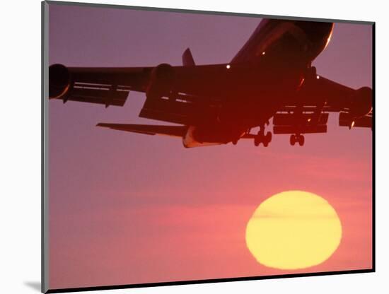 Airplane in Flight During Sunrise, Sunset-Mitch Diamond-Mounted Photographic Print