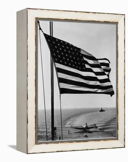 Airplane on Battleship Deck with American Flag in Foreground, World War II-null-Framed Stretched Canvas