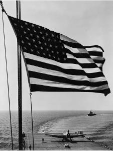 Airplane on Battleship Deck with American Flag in Foreground, World War II