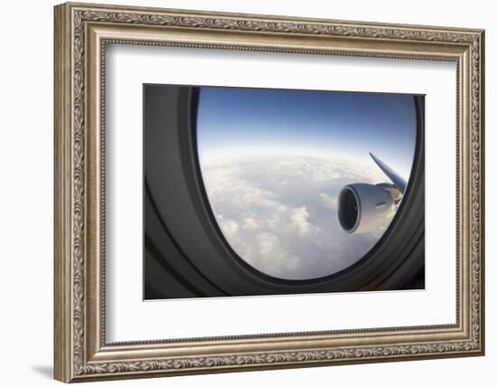 Airplane Window Looking Out on Cloudy Sky-Paul Souders-Framed Photographic Print