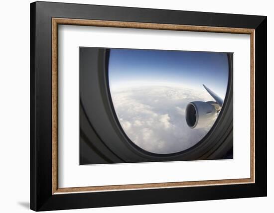 Airplane Window Looking Out on Cloudy Sky-Paul Souders-Framed Photographic Print