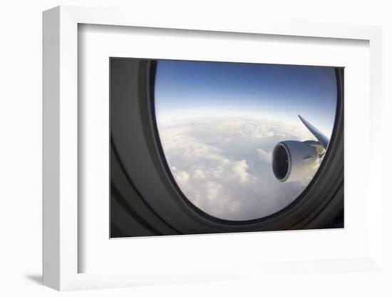 Airplane Window Looking Out on Cloudy Sky-Paul Souders-Framed Photographic Print