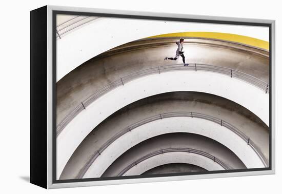 Airport Car Park, Stuttgart, Baden-Württemberg, Germany: A Male Runner Running Through A Car Park-Axel Brunst-Framed Premier Image Canvas