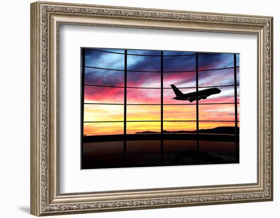 Airport Window with Airplane Flying at Sunset-viperagp-Framed Photographic Print