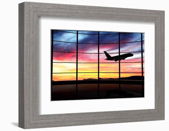 Airport Window with Airplane Flying at Sunset-viperagp-Framed Photographic Print