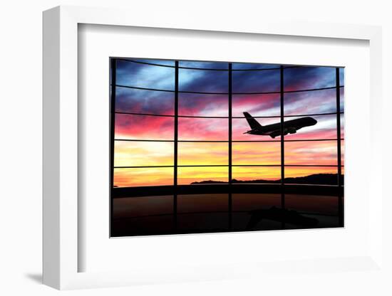 Airport Window with Airplane Flying at Sunset-viperagp-Framed Photographic Print