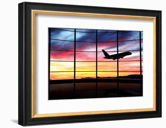 Airport Window with Airplane Flying at Sunset-viperagp-Framed Photographic Print