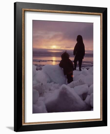 Alaska: Silhoutte of Native Alaskan Children Watching the Midnight Sun-Ralph Crane-Framed Photographic Print