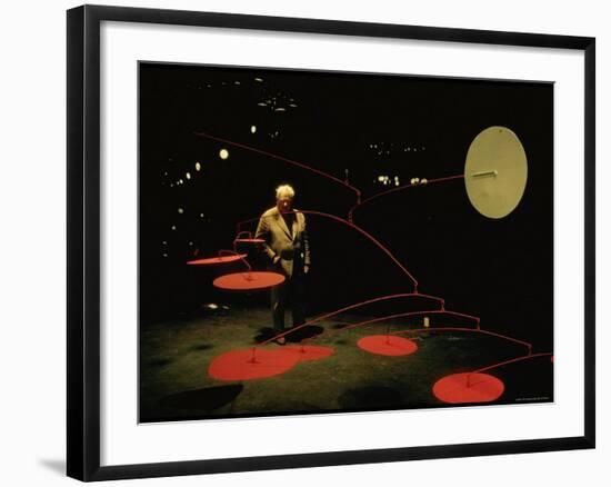 Alexander Calder Walking Past Exhibit of His Mobiles at the Guggenheim Museum-Gjon Mili-Framed Premium Photographic Print