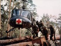 American 4th Battalion, 173rd Airborne Brigade Soldiers Loading Wounded Onto a "Huey" Helicopter-Alfred Batungbacal-Photographic Print