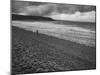 Along British Coastline, Woman Walking on Pebbled Shore-Nat Farbman-Mounted Photographic Print