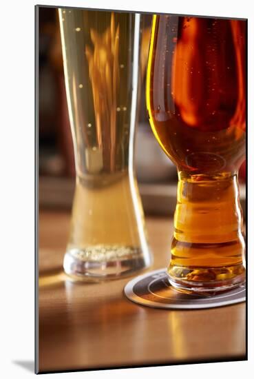 Amber Ale And Lager Style Beer Next To Each Other At A Bar-Shea Evans-Mounted Photographic Print