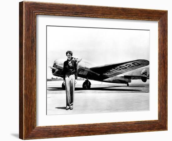 Amelia Earhart Standing in Front of the Lockheed Electra in Which She Disappeared in July 29, 1937-null-Framed Photo