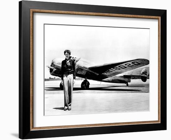 Amelia Earhart Standing in Front of the Lockheed Electra in Which She Disappeared in July 29, 1937-null-Framed Photo