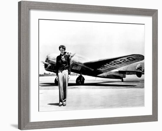 Amelia Earhart Standing in Front of the Lockheed Electra in Which She Disappeared in July 29, 1937-null-Framed Photo