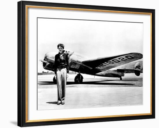 Amelia Earhart Standing in Front of the Lockheed Electra in Which She Disappeared in July 29, 1937-null-Framed Photo