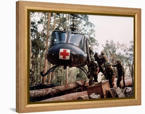 American 4th Battalion, 173rd Airborne Brigade Soldiers Loading Wounded Onto a "Huey" Helicopter-Alfred Batungbacal-Framed Premier Image Canvas