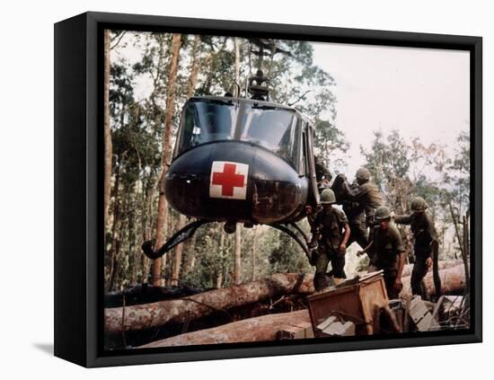 American 4th Battalion, 173rd Airborne Brigade Soldiers Loading Wounded Onto a "Huey" Helicopter-Alfred Batungbacal-Framed Premier Image Canvas