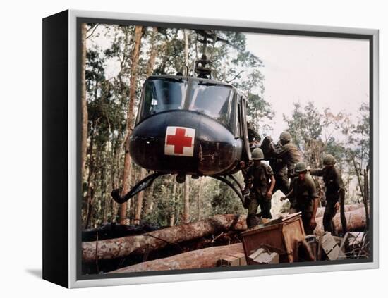 American 4th Battalion, 173rd Airborne Brigade Soldiers Loading Wounded Onto a "Huey" Helicopter-Alfred Batungbacal-Framed Premier Image Canvas