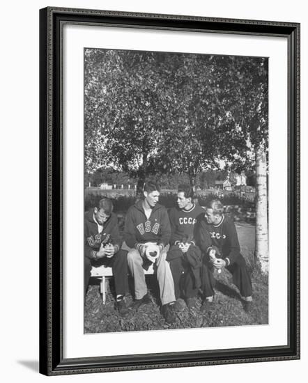 American and Russian Olympic Athletes Sitting on Bench and Talking-Ralph Crane-Framed Premium Photographic Print